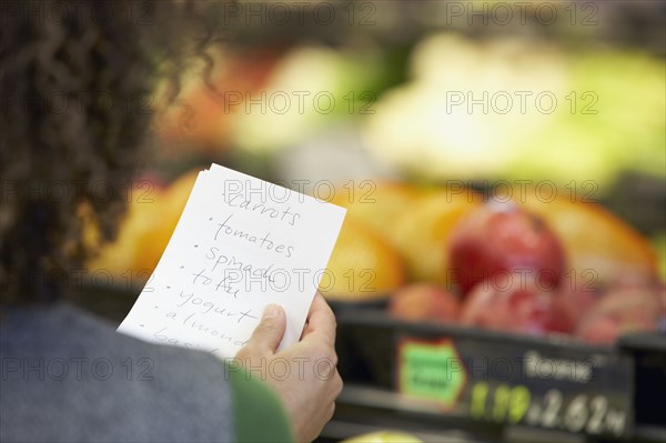 African woman reading grocery list