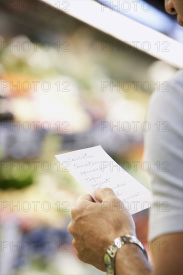 Hispanic man reading grocery list