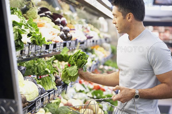 Hispanic man shopping for produce