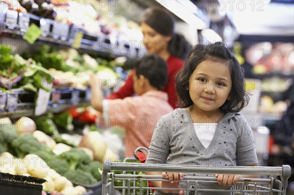 Indian girl sitting in shopping cart