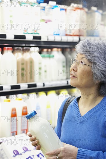 Senior Asian woman shopping in grocery store