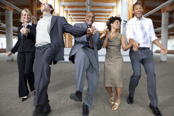 Business people dancing in empty office space