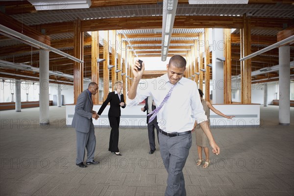 Business people dancing in empty office space