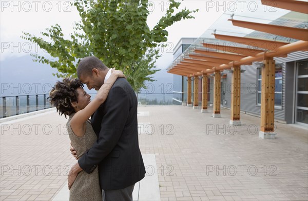 Couple hugging in courtyard