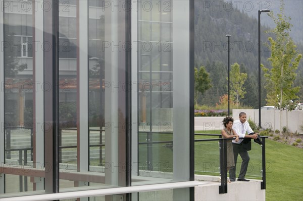 Business people standing on balcony