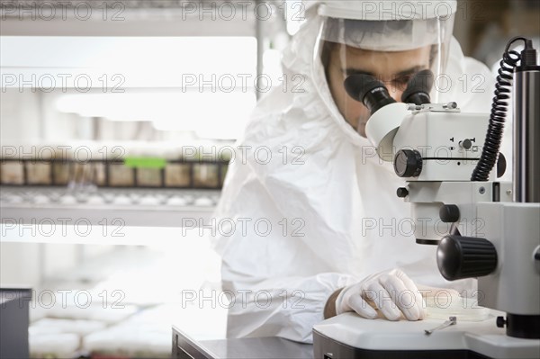 Middle Eastern scientist using microscope in laboratory