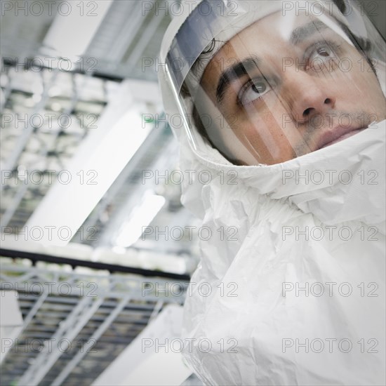 Middle Eastern scientist in clean suit in laboratory