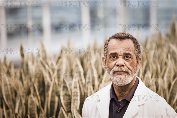 African American scientist working in greenhouse