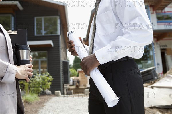 Real estate agents near house under construction