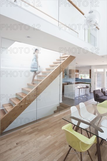 Mixed race girl walking up staircase