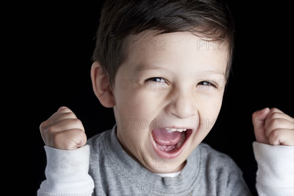 Close up of Hispanic boy cheering