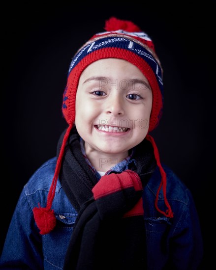 Close up of Hispanic boy wearing warm clothing