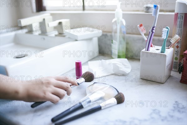 Hand of Hispanic woman holding makeup brush
