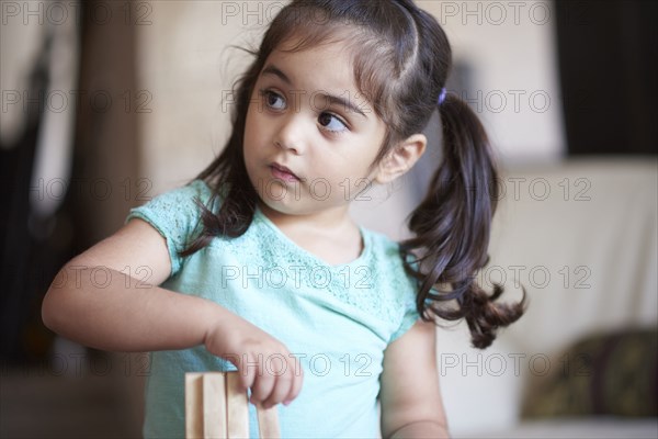 Curious Hispanic girl looking away