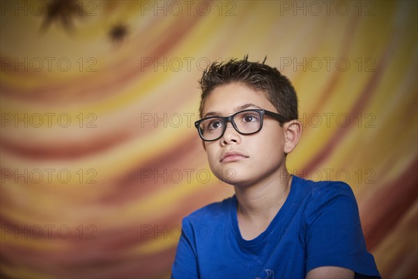 Curious Hispanic boy looking away