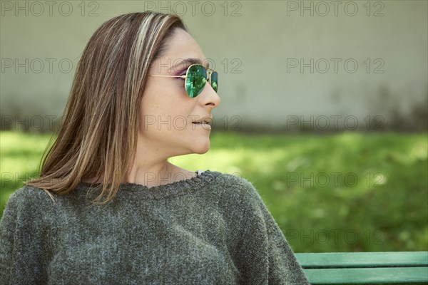 Hispanic woman wearing sunglasses