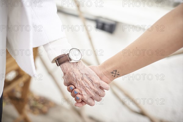 Grandmother and granddaughter holding hands