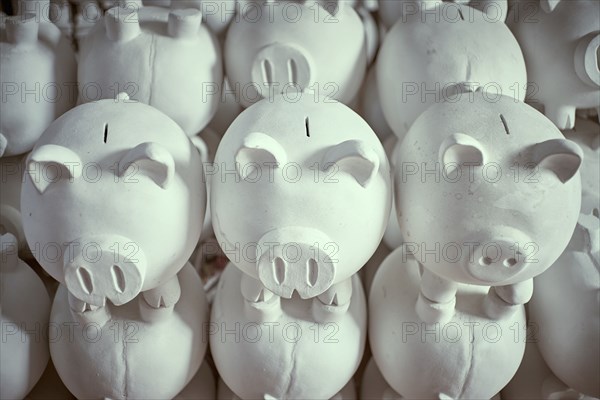 Pile of white piggybanks