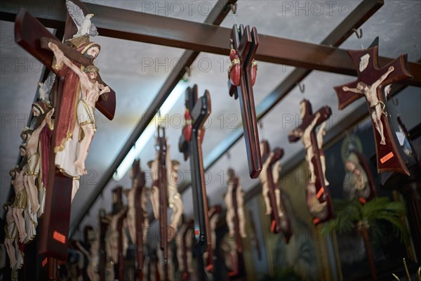 Crucifixes handing on beams in shop