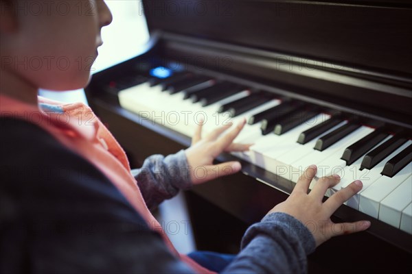 Hispanic boy playing piano