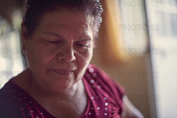 Hispanic woman looking down