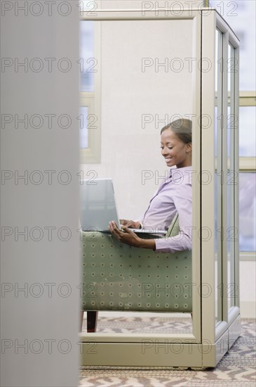 African businesswoman working on laptop in office