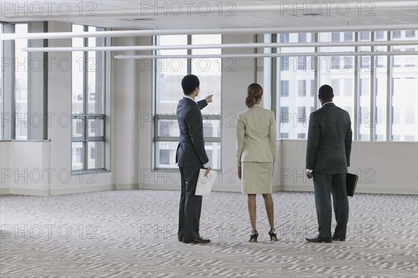 Multi-ethnic business people viewing empty building