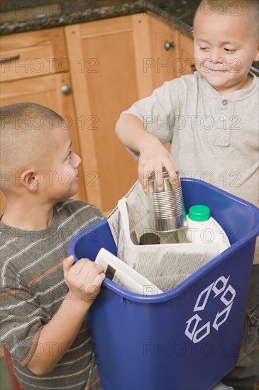 Hispanic brothers recycling