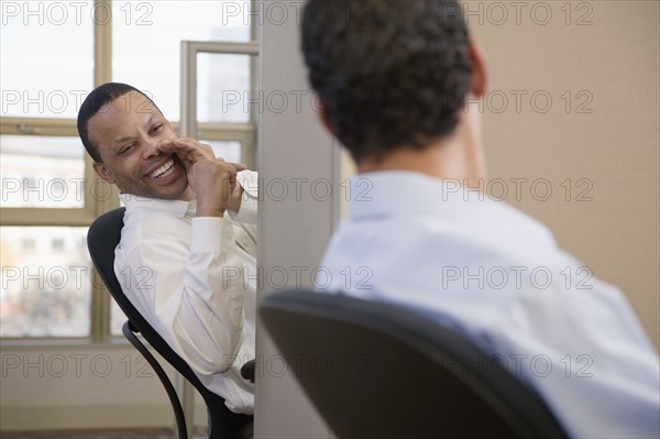 Businessmen exchanging gossip