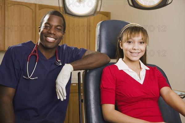 African dentist with teenage patient