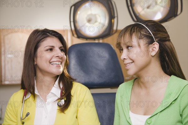 Teenage girl having checkup in doctor's office