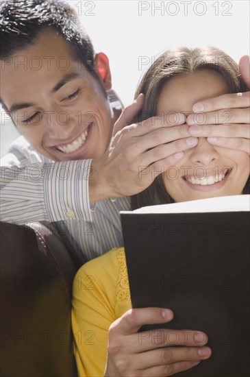 Boyfriend covering girlfriend's eyes