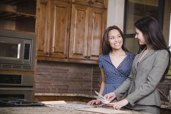 Hispanic woman working with interior designer