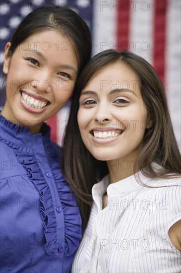 Friends standing near American flag