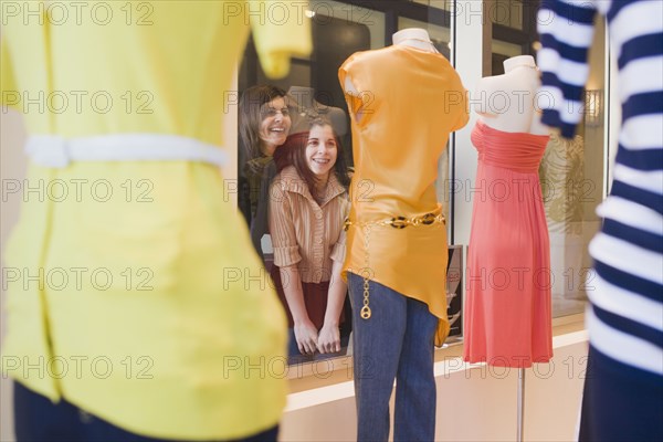 Middle Eastern mother and daughter window shopping