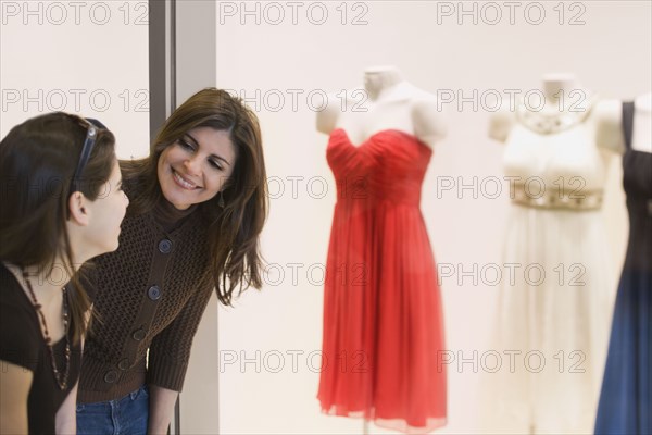 Middle Eastern mother and daughter window shopping