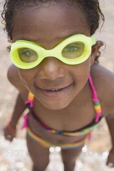 Smiling African girl wearing goggles and bikini