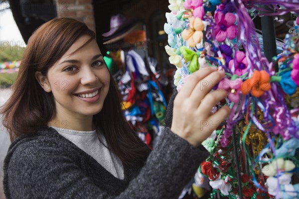 Mixed race woman looking at souvenir shop