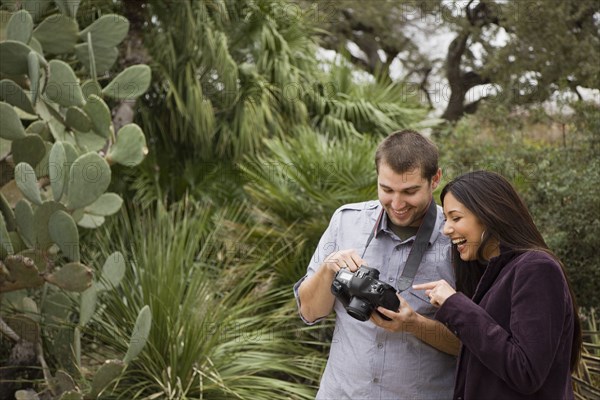 Couple looking at pictures on digital camera