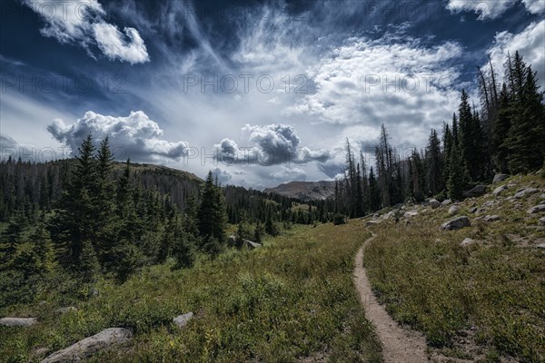 Clouds over trail in rocky landscape