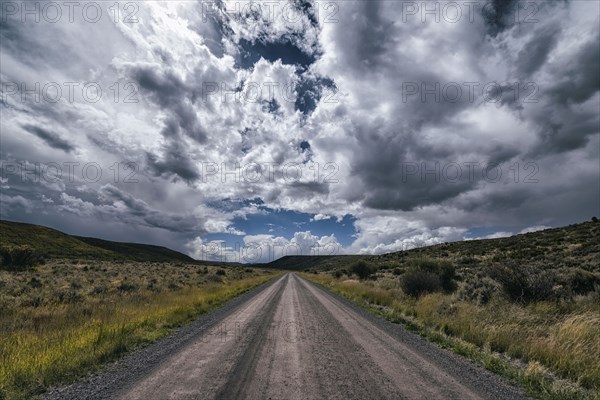 Remote dirt road under clouds
