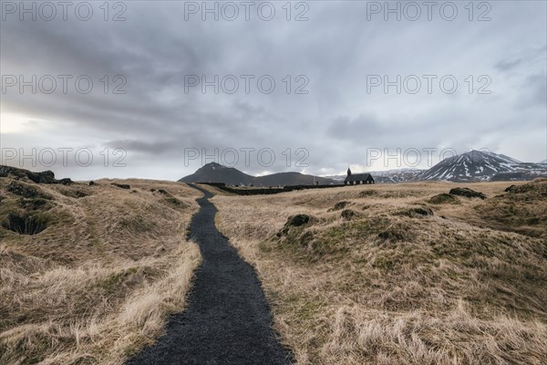 Dirt road to distant church