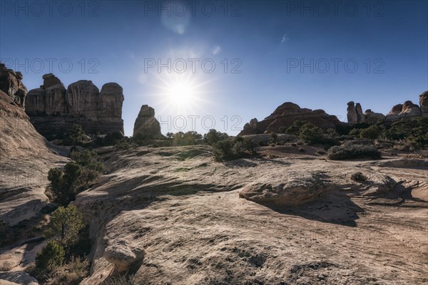 Sun in blue sky over desert