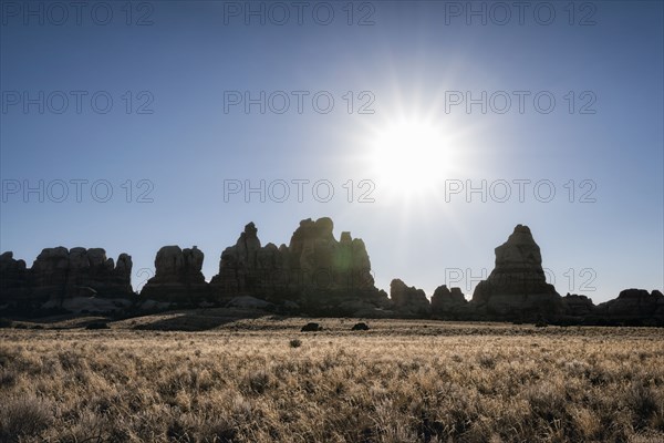 Sun in blue sky over desert