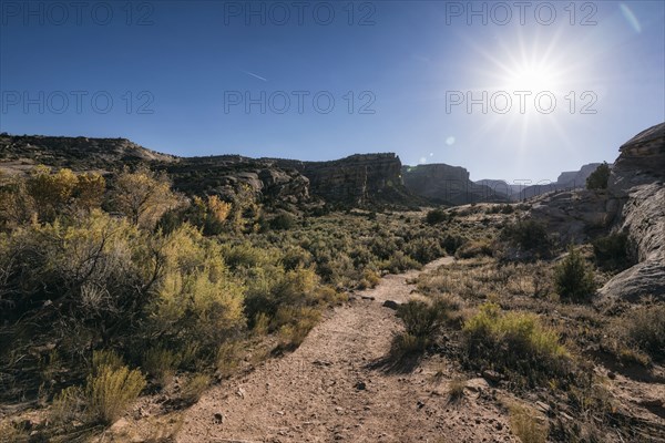 Sun in blue sky over desert