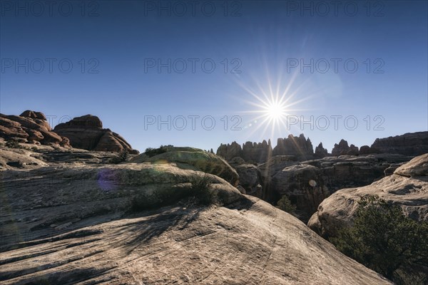 Sun in blue sky over desert