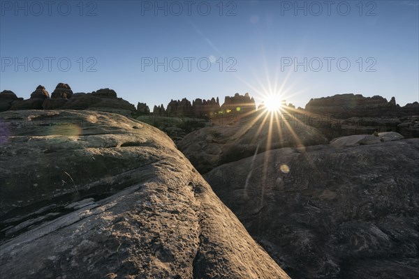 Sun in blue sky over desert