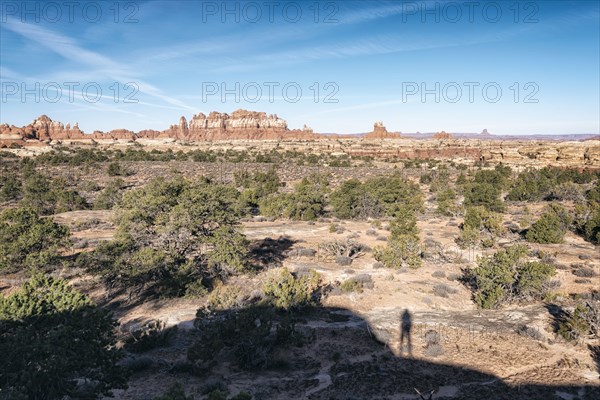 Shadow of person admiring scenic view of desert