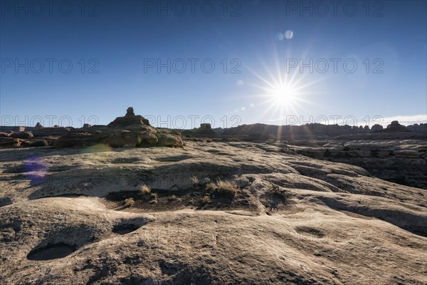 Sun in blue sky over desert