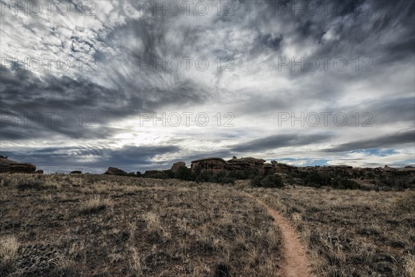 Clouds over desert path